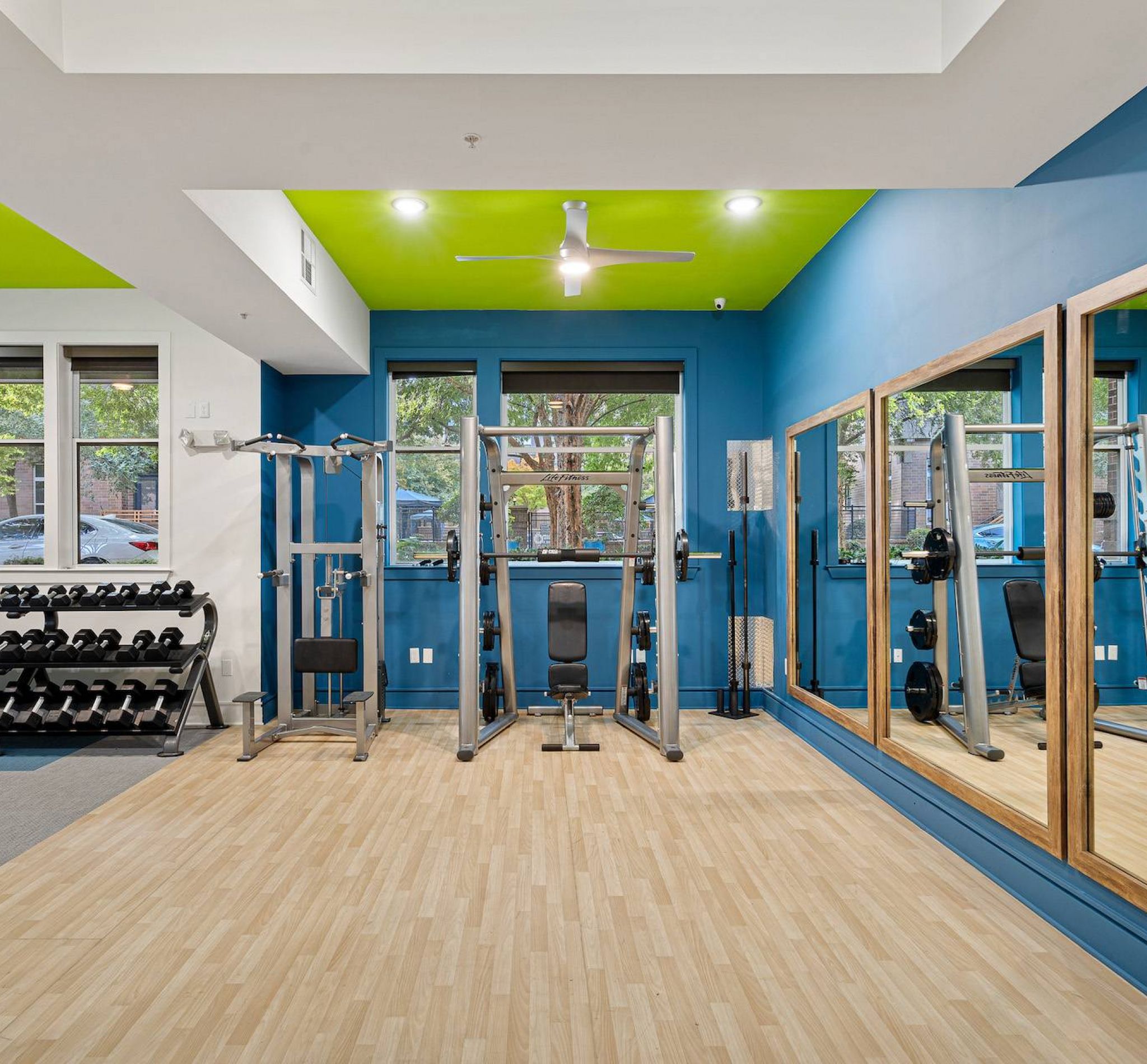 Renovated fitness center with blue walls at 808 Hawthorne apartments