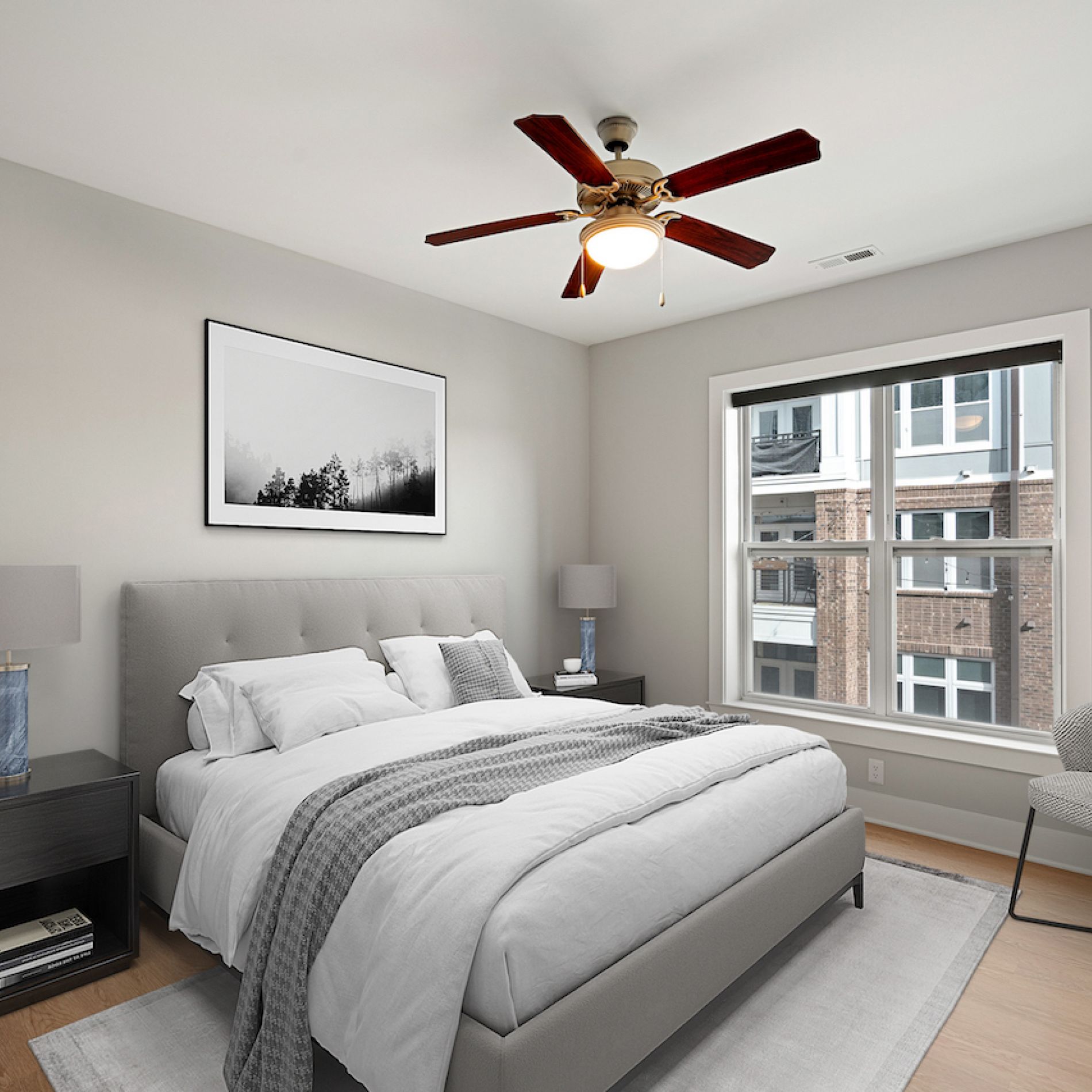 Neutral-colored bedroom with large ceiling fan in apartment